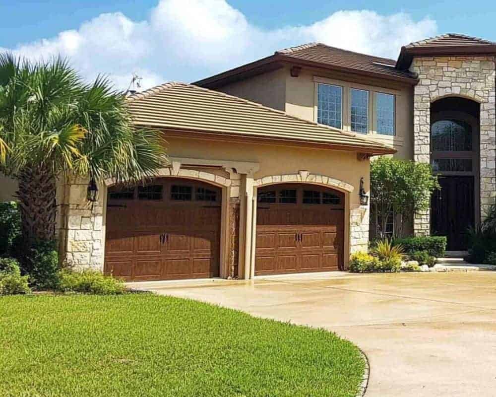 Technical specialist executing detailed garage door repair services on an tracking mechanism