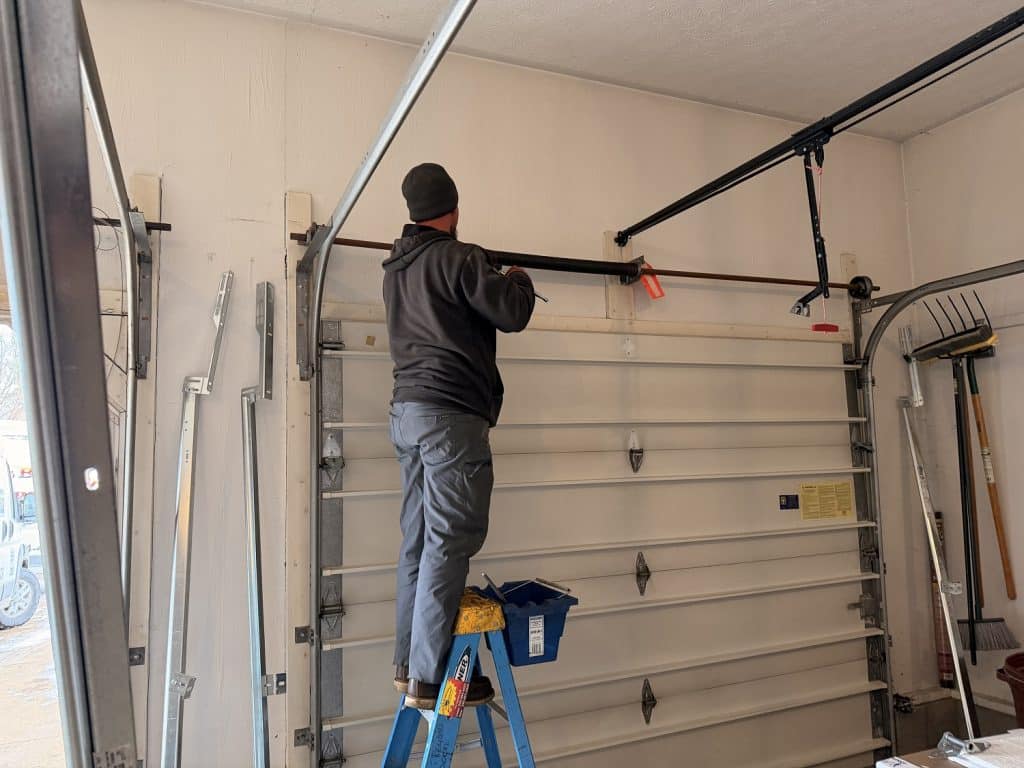 Technician repairing a LiftMaster garage door opener motor in San Antonio, TX