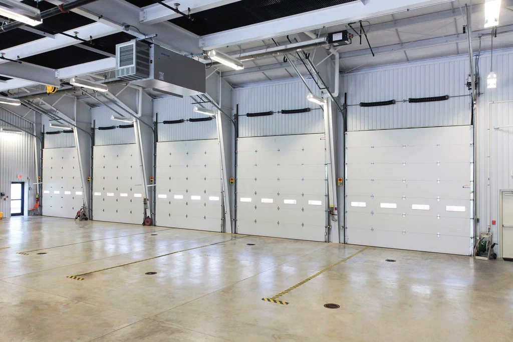 Technician servicing an overhead garage door